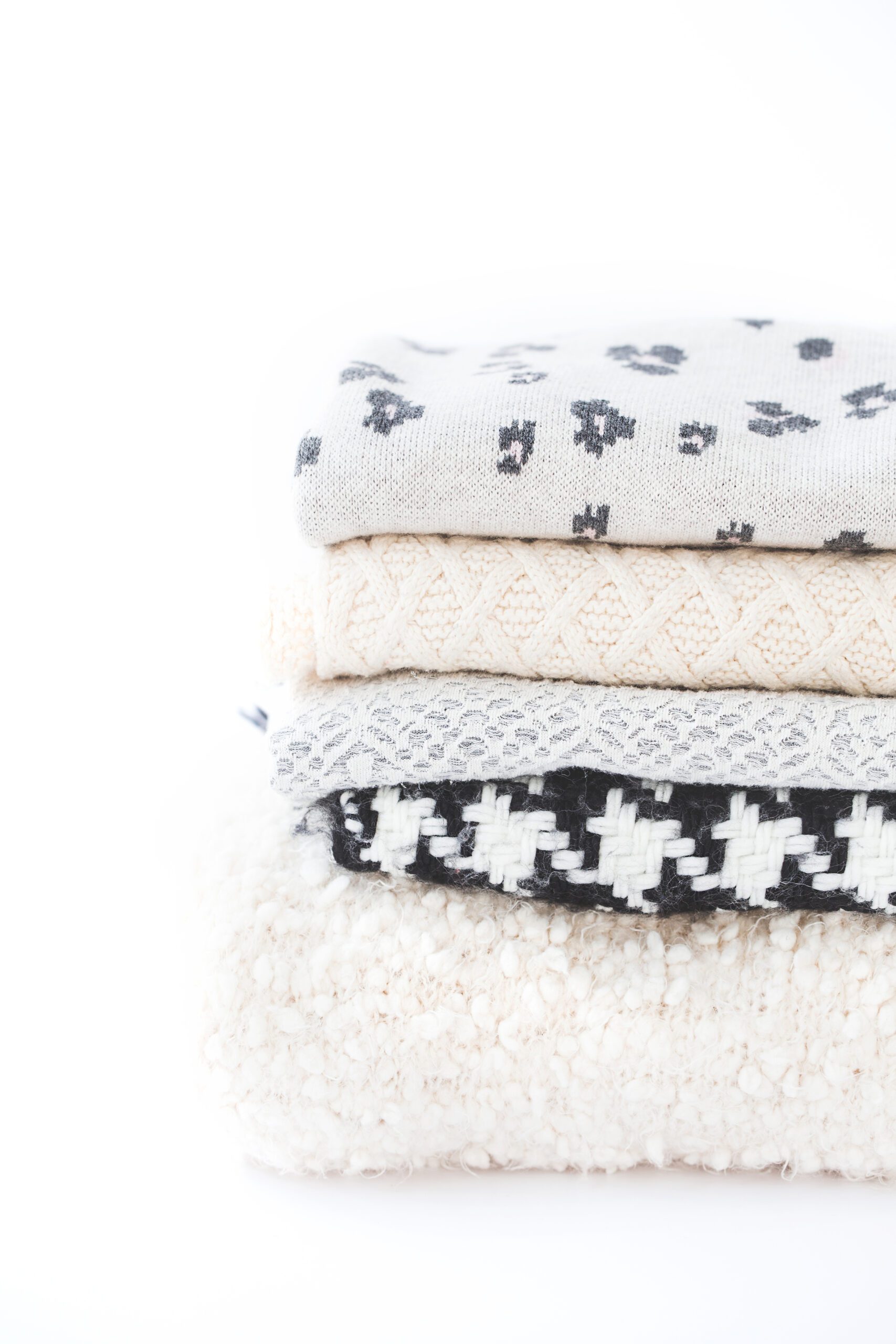 A pile of neatly folded jumpers and sweaters - Marie Kondo KonMari Method