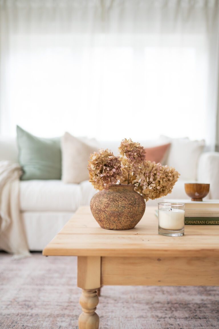 A vase of dried hydrangeas on a coffee table