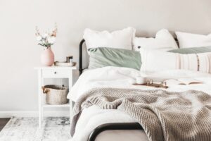 A bedroom scene with a bed and nightstand