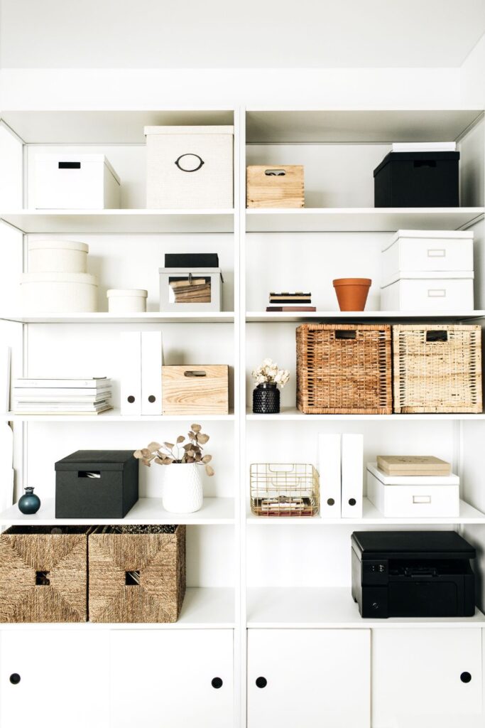 A modern minimalist storage unit with shelves and baskets for dealing with paper clutter
