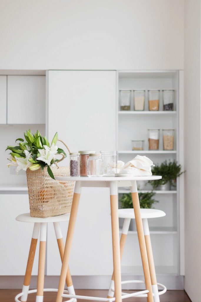 A modern white kitchen with pantry shelves