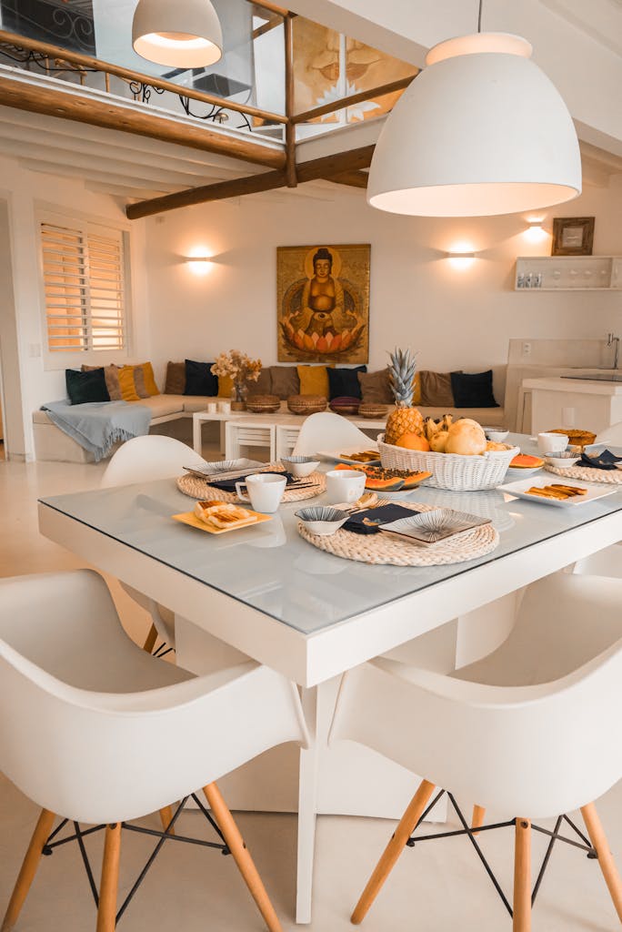 Elegant white dining room with contemporary furniture and cozy decor, ideal for family gatherings.