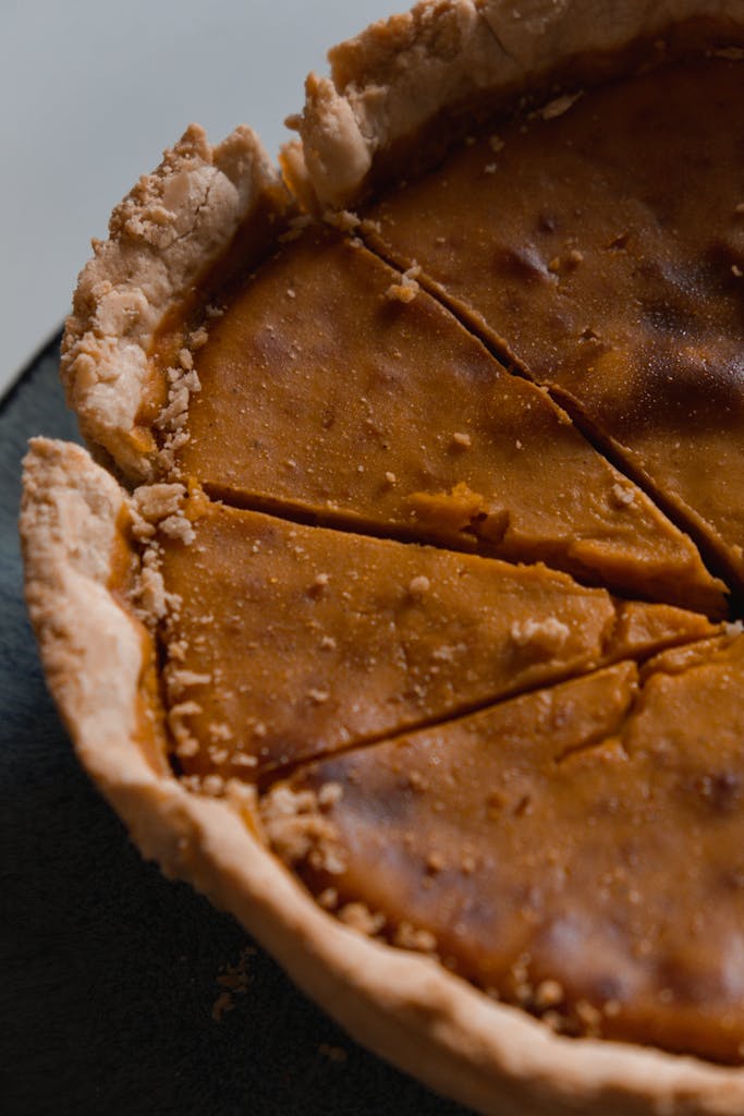 Appetizing close-up of a sliced homemade pumpkin pie, perfect for fall desserts.