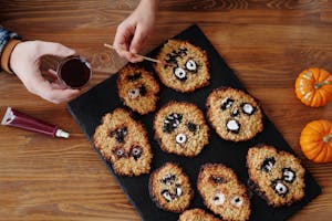 Creative Halloween monster cookies being decorated for a fun holiday treat.