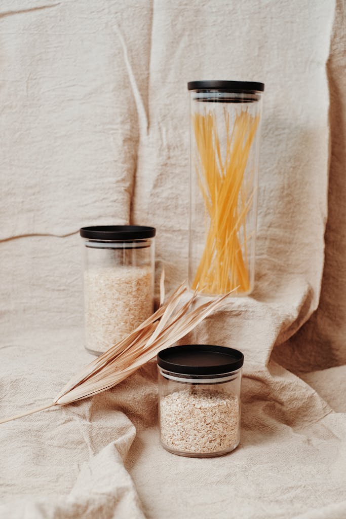 Eco-friendly storage solution with pasta and grains in reusable glass jars, promoting sustainability.
