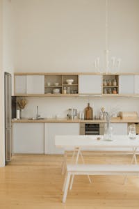 Stylish kitchen interior with minimalistic design and modern wooden elements.