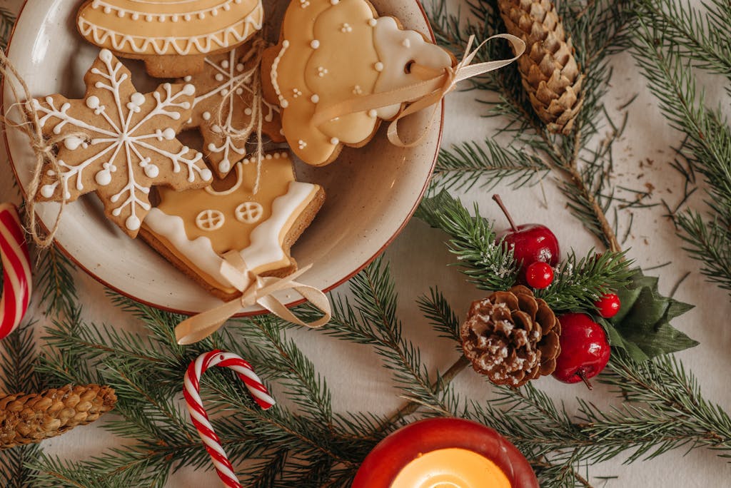 A cozy flatlay of Christmas cookies, pine cones, and candies for a festive holiday setting.