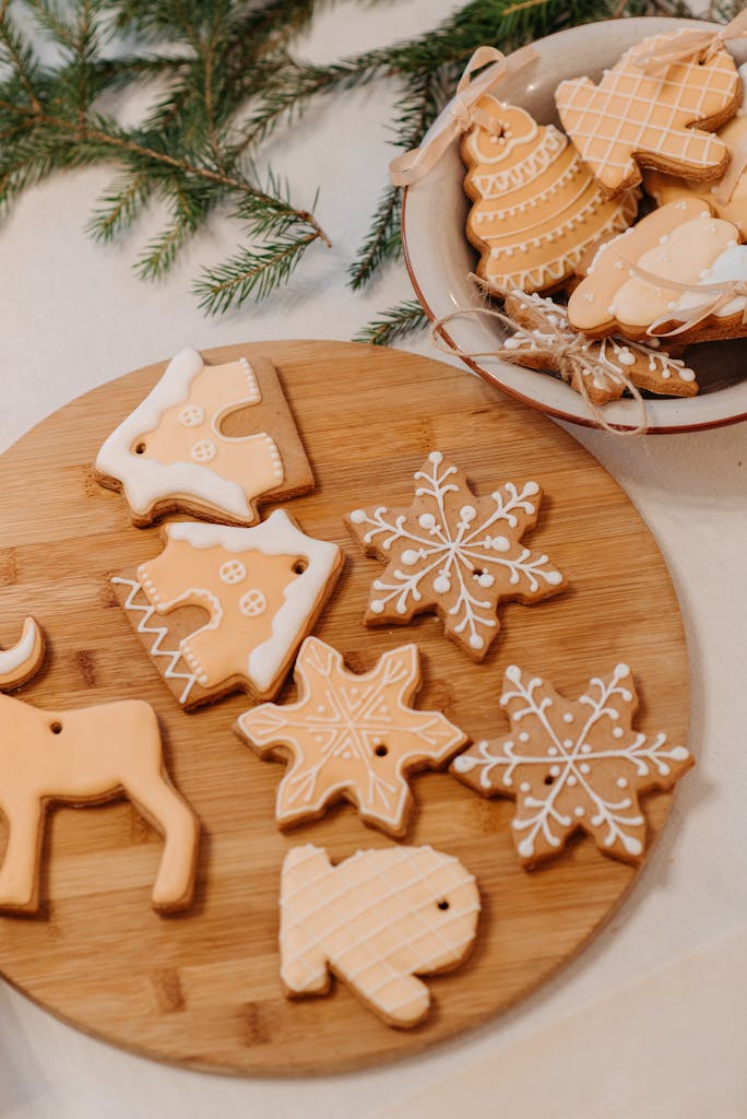 Delicious festive cookies decorated for Christmas with icing on a wooden plate.