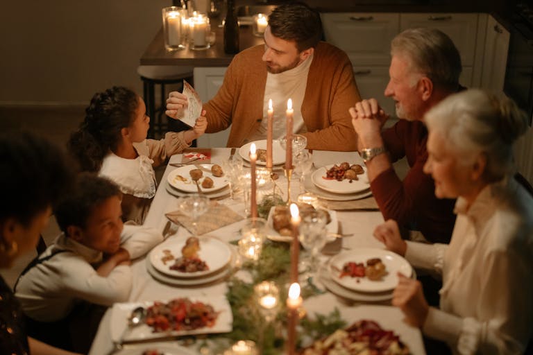 Warm and festive family dinner during Christmas with candles and joy.